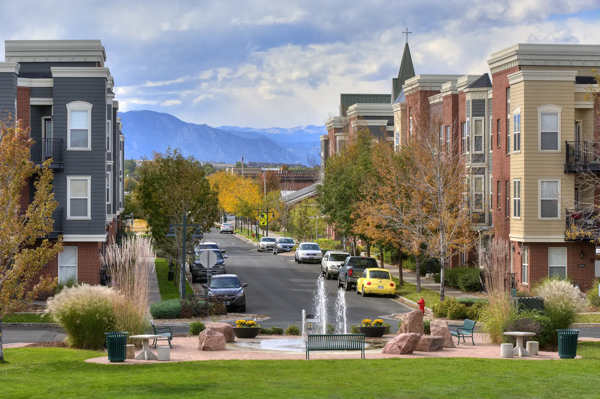 Tree lined residential street with view of mountains