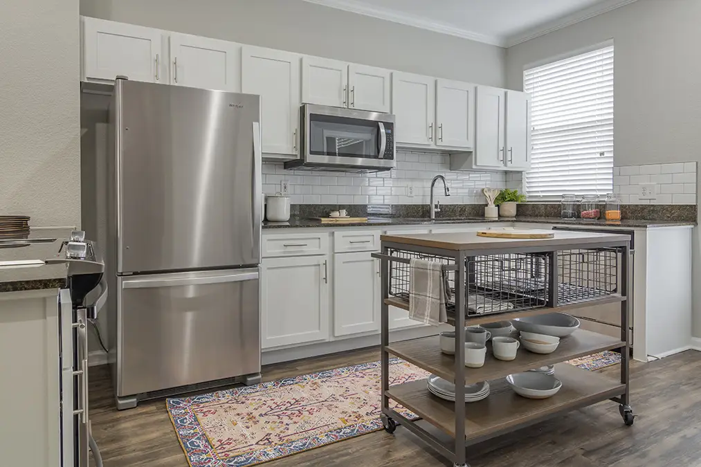 Kitchen with stainless steel appliances, tile backsplash, and granite counter tops