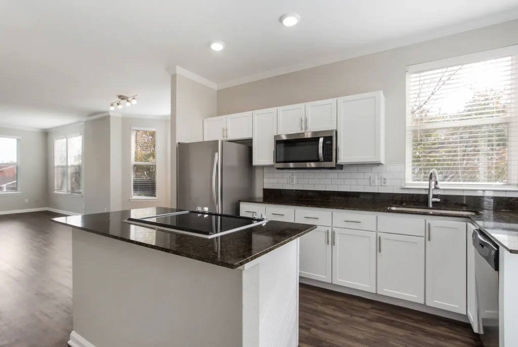 Kitchen with stainless steel appliances, tile backsplash, and granite counter tops