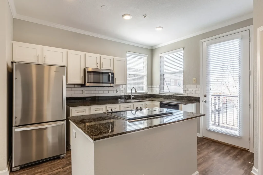 Kitchen with stainless steel appliances, tile backsplash, and granite counter tops