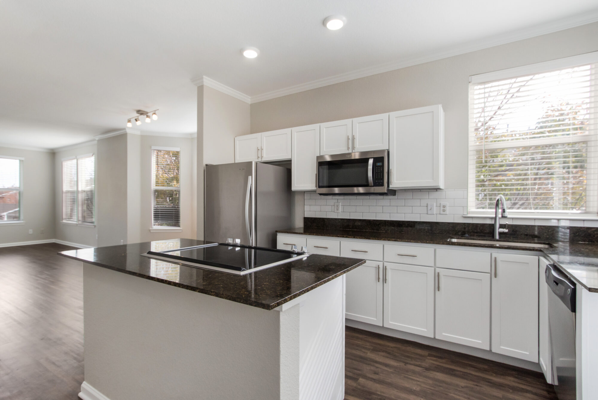 Kitchen with stainless steel appliances, granite counter tops, and tile backsplash