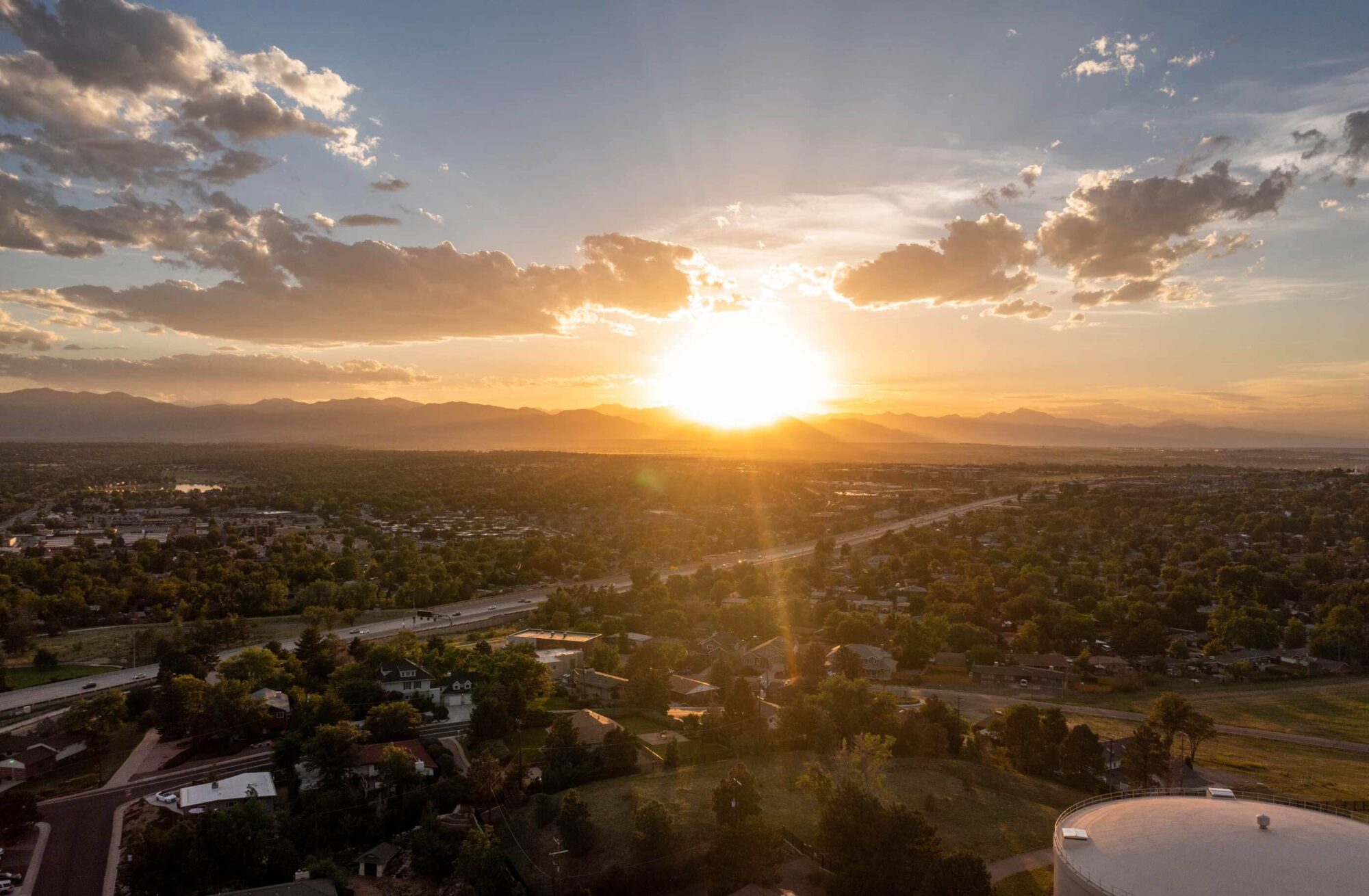 Aerial view of Westminster Colorado at sunset, Mountains in the distance